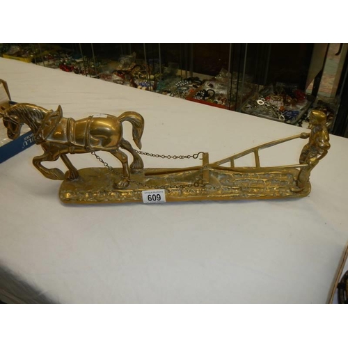 609 - A large solid brass figure of a working horse and ploughman, length 50 cm.