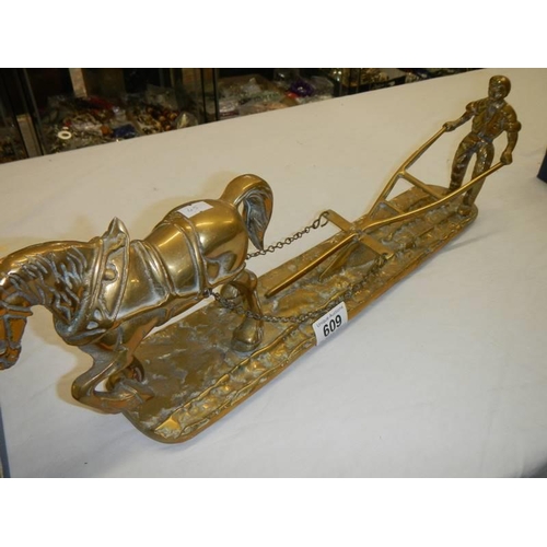 609 - A large solid brass figure of a working horse and ploughman, length 50 cm.