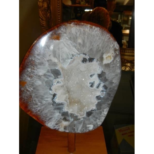 622 - A polished agate geode on stand.