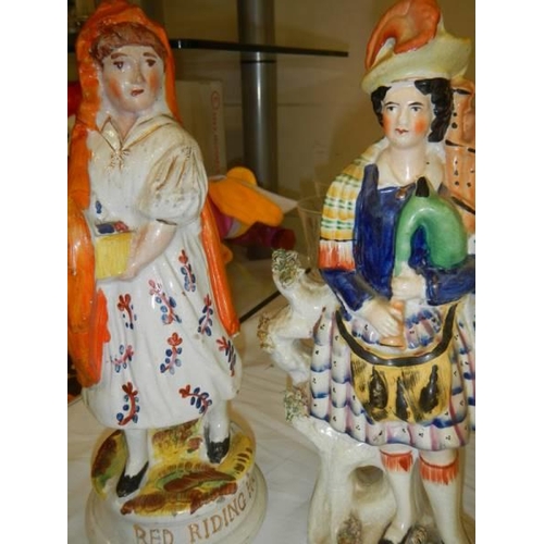 637 - A 19th century Staffordshire figure of Red Riding Hood and another of a bagpipe player.