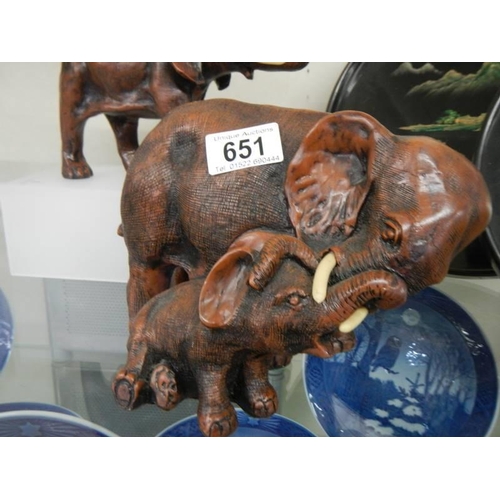 651 - A resin mother and baby elephants and one other.