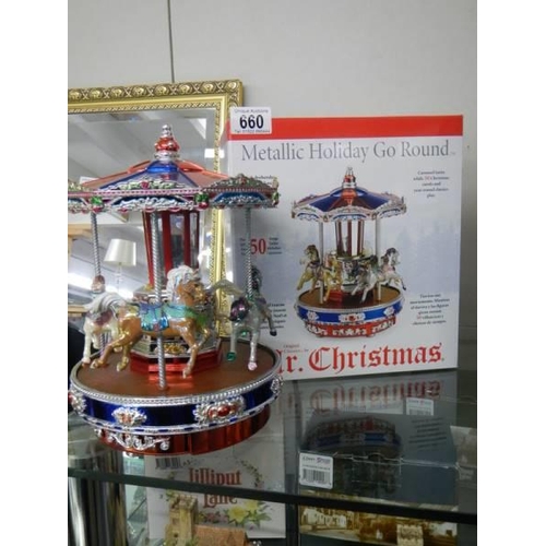 660 - A boxed Mr Christmas musical metallic holiday go round, plays 50 Christmas and all year tunes, in wo... 