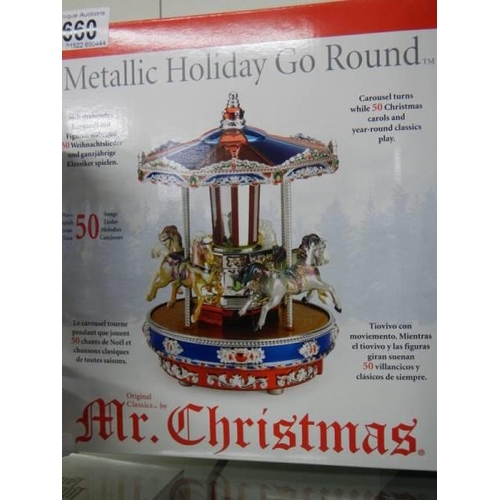 660 - A boxed Mr Christmas musical metallic holiday go round, plays 50 Christmas and all year tunes, in wo... 