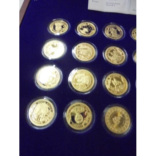 219 - A limited edition cased set of 24 gold plate on copper Historic Moments of Queen Elizabeth II coins.