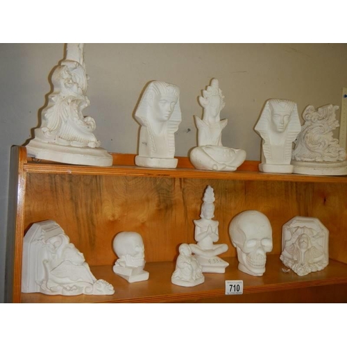 710 - A good selection of plaster ornaments including Egyptian, Indian, skulls, cherub wall brackets etc.,