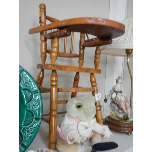 742 - A wooden doll high chair with a Beatrix Potter frog soft toy. COLLECT ONLY.