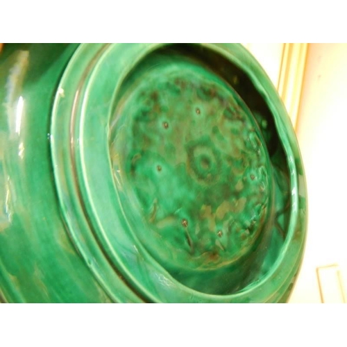 743 - A green glazed pottery collector's plate.