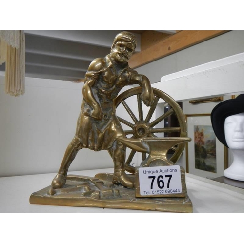 767 - A solid brass figure of a Blacksmith.