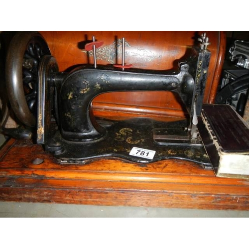 781 - A vintage cased Singer sewing machine, COLLECT ONLY.