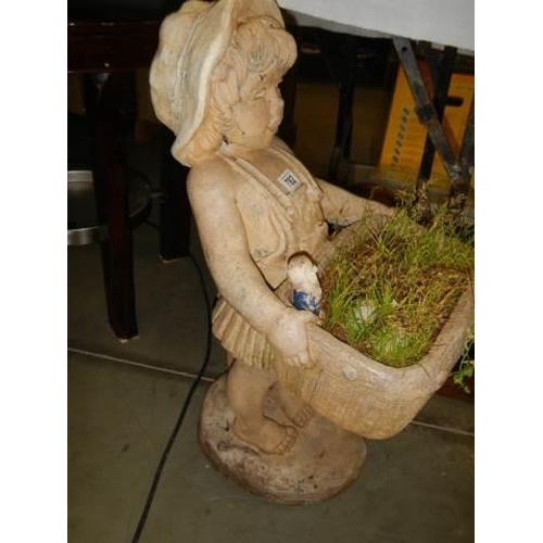 782 - A composite stone garden statue of a boy carrying a planter. COLLECT ONLY.