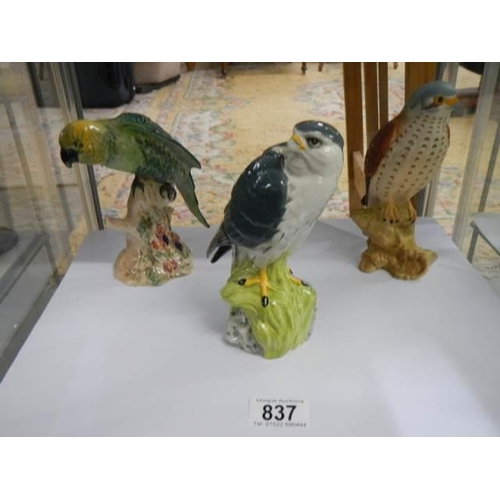 837 - Two Beswick bird figures and a Merlin by Royal Doulton for Whyte and Mackay.