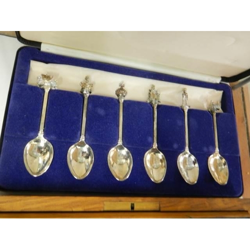 838 - A cased set of knives and forks (missing 2 forks) and a cased set of spoons.