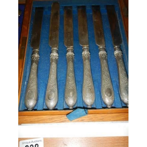 838 - A cased set of knives and forks (missing 2 forks) and a cased set of spoons.