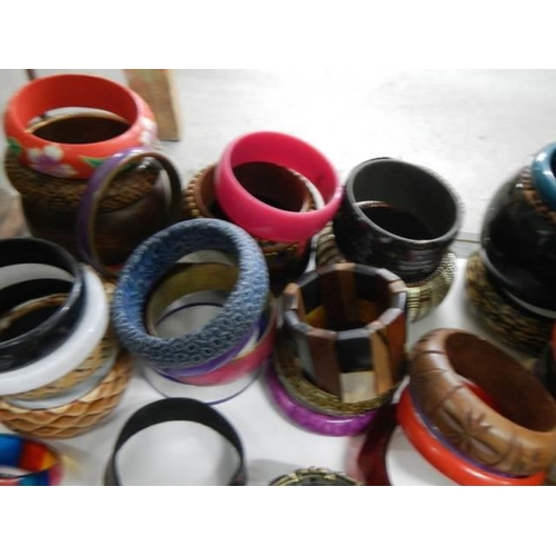 843 - Approximately fifty fashion bangles.