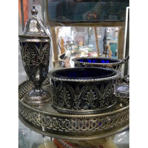 890 - A silver plate three piece condiment set on tray (mustard pot lid needs repair).