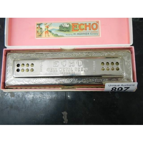 897 - A boxed vintage Hohner Echo harmonica.