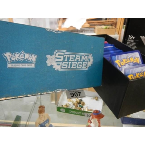 907 - A quantity of Pokemon cards in steam seige box.