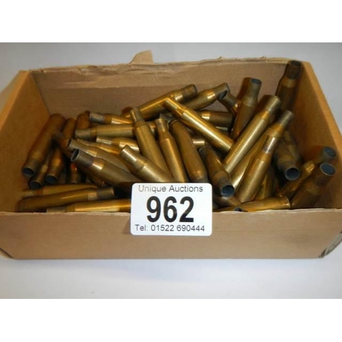 962 - A box of spent brass rifle shells.