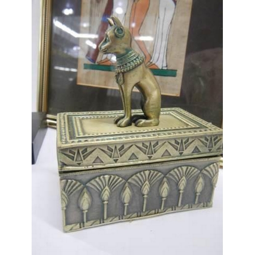 963 - An Egyptian picture and two Egyptian God Bastet items.