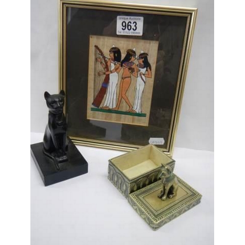 963 - An Egyptian picture and two Egyptian God Bastet items.