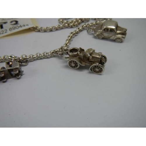 973 - A hall marked silver charm bracelet with charms.