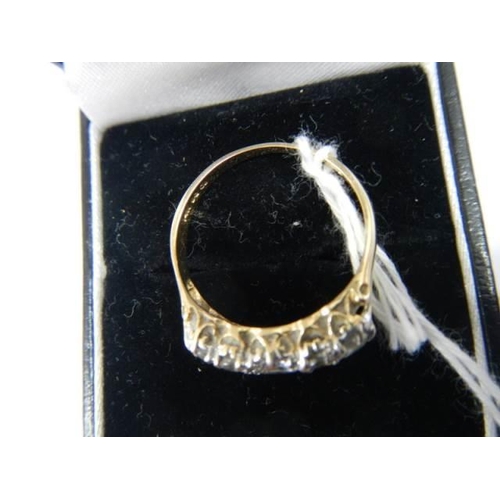 976 - A 9ct gold ring set five clear stones, size P, 2.6 grams.