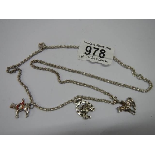 978 - A hall marked silver neck chain with horse charms.