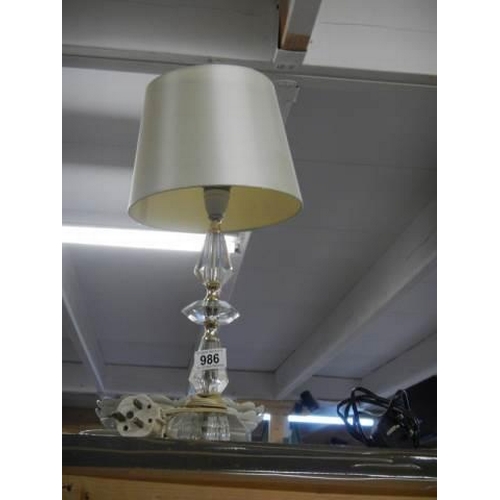 986 - A heavy glass table lamp with shade.