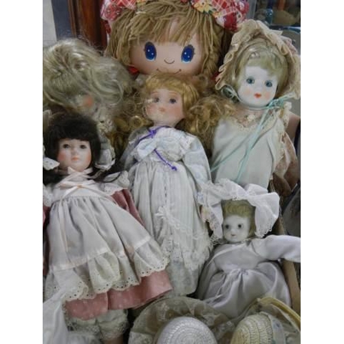 998 - A collection of porcelain dolls and a Hug Me rag doll.