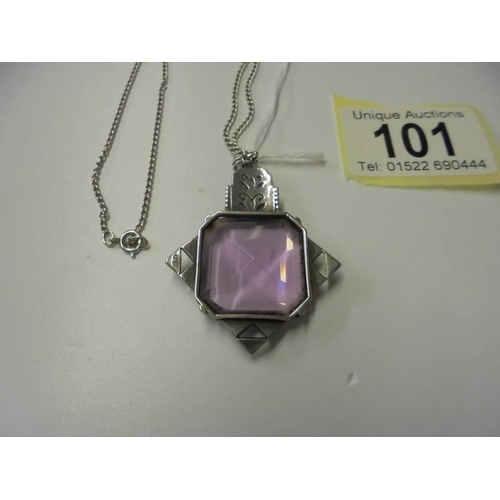 101 - A silver pendant set large amethyst coloured stone.