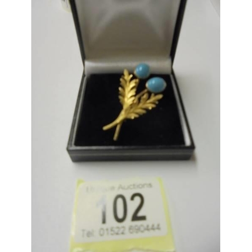 102 - A superb quality yellow metal brooch set turquoise coloured stones stamped 12k.