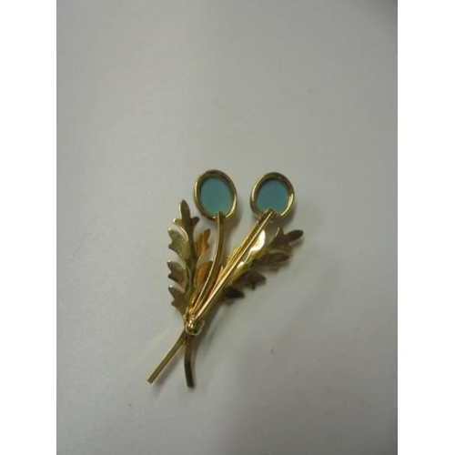 102 - A superb quality yellow metal brooch set turquoise coloured stones stamped 12k.