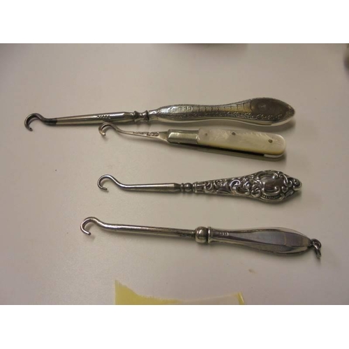 172 - 3 silver handled button hooks, a silver & mother of pearl button hook, a silver sauce ladle, silver ... 