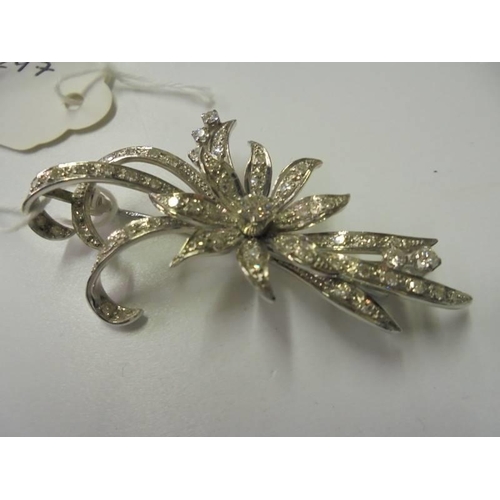 103 - A superb quality 18ct white gold and diamond set brooch as a flower spray. (11.8gms)