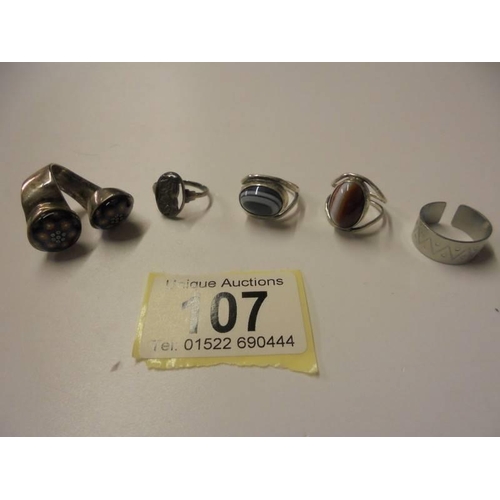 107 - Three silver rings and three white metal rings.