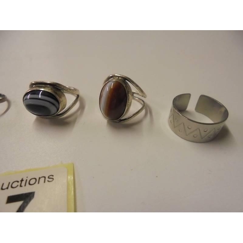 107 - Three silver rings and three white metal rings.