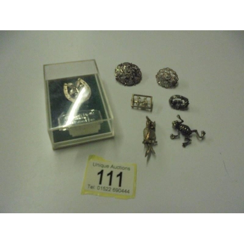 111 - A mixed lot of brooches including silver.