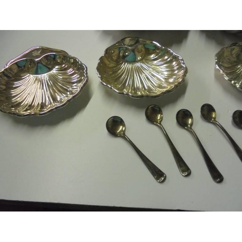 240 - A quantity of silver plate 'Scallop' dishes and six salt spoons.