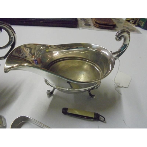 241 - A pair of silver plate sauce boats, spoons, sugar nips etc.,