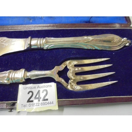 242 - A cased pair of silver plate fish servers.