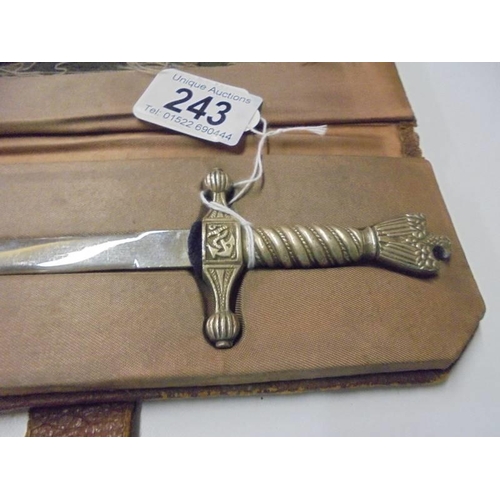 243 - A cased letter opener in the form of a dagger with eagle feature.