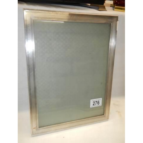 276 - A silver photo frame, 30.5 x 23.5 cm.