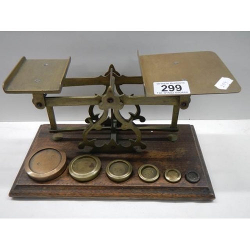 299 - A good set of brass post office scales with weights.