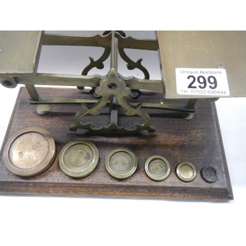 299 - A good set of brass post office scales with weights.