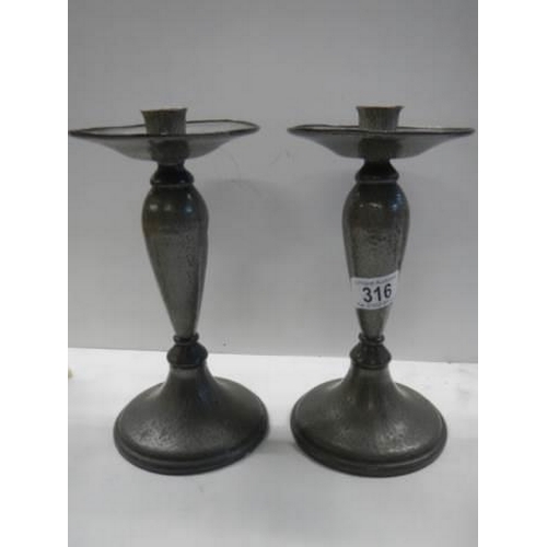 316 - A pair of Tudric pewter candlesticks.