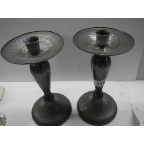 316 - A pair of Tudric pewter candlesticks.