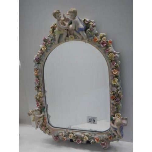 319 - A 20th century porcelain framed mirror with cherubs and flowers, COLLECT ONLY.