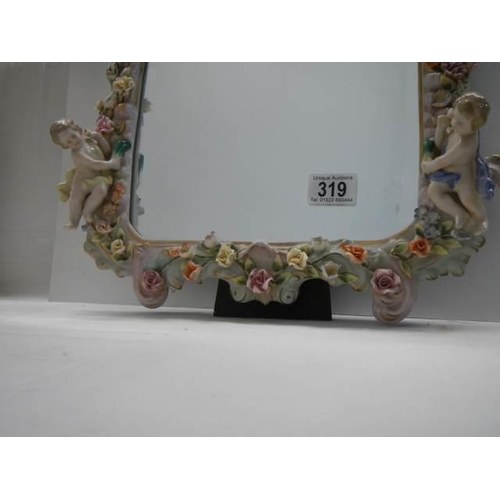 319 - A 20th century porcelain framed mirror with cherubs and flowers, COLLECT ONLY.