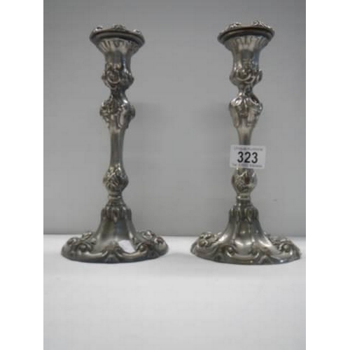 323 - A pair of art nouveau style silver plate candlesticks.