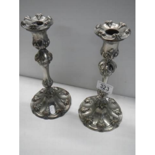 323 - A pair of art nouveau style silver plate candlesticks.